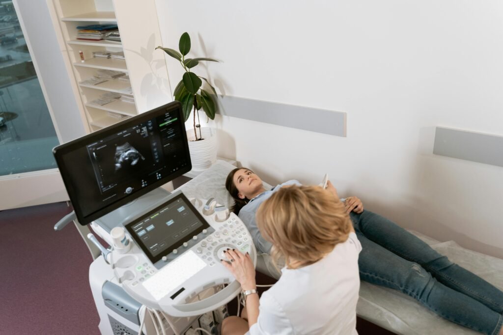 pexels-photo-7089629-7089629 Pregnant woman receiving ultrasound consultation from medical professional in clinic.
