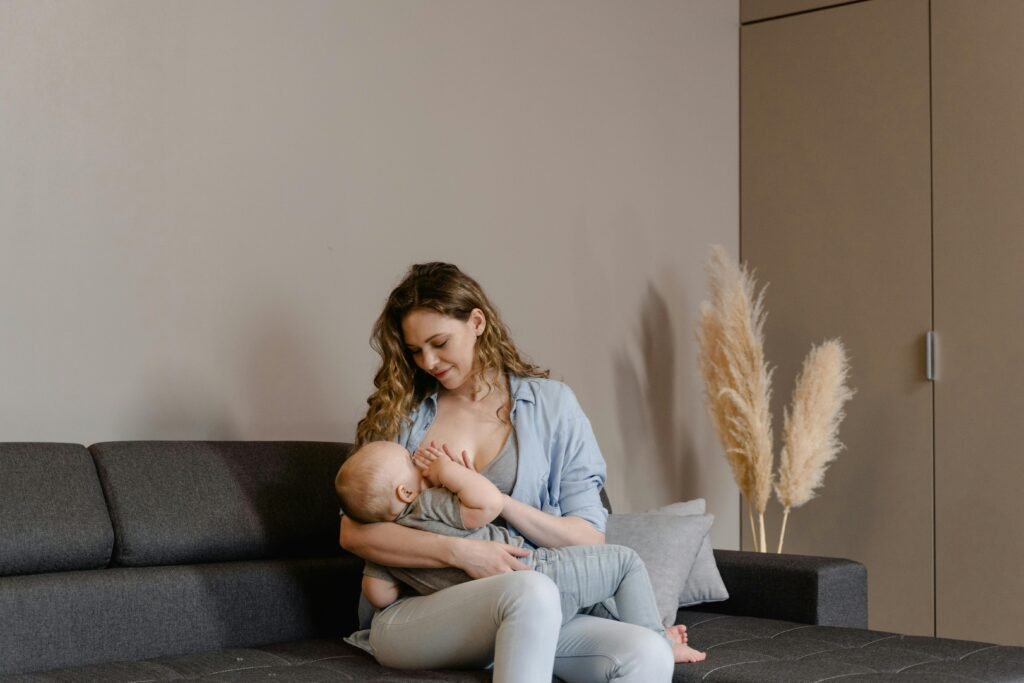 pexels-photo-7491221-7491221 A tender moment of motherhood as a mother breastfeeds her baby on a sofa, indoors.