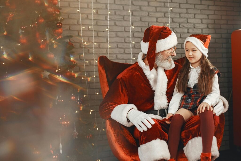 A child sitting on Santa Claus's lap, surrounded by holiday decorations.