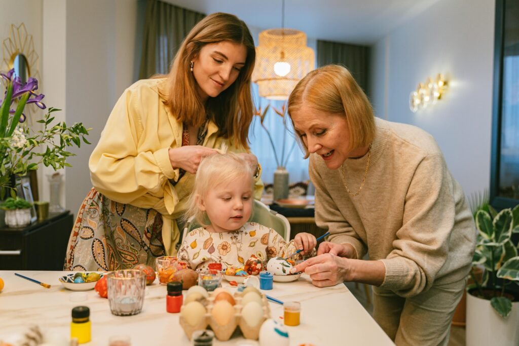 Family enjoying a fun-filled day painting Easter eggs together indoors.